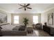 Staged main bedroom featuring a ceiling fan, ensuite, and wood flooring at 2331 Bouldercliff Se Way, Atlanta, GA 30316
