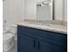 Bathroom vanity with granite countertop, navy blue cabinetry, and modern fixtures at 3920 Bellair Dr, Marietta, GA 30066