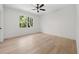 Bright bedroom featuring hardwood floors, large window and modern ceiling fan at 3920 Bellair Dr, Marietta, GA 30066