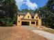 Exterior view of a two-story house under construction with a gravel driveway and surrounding trees at 3920 Bellair Dr, Marietta, GA 30066