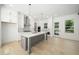 Modern kitchen with a central island, stainless appliances, and hardwood floors at 3920 Bellair Dr, Marietta, GA 30066