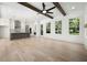 Open-concept living room and kitchen area with hardwood floors, natural light, white walls and exposed beam ceiling at 3920 Bellair Dr, Marietta, GA 30066