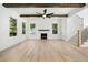 Bright living room with fireplace, staircase, and exposed wooden beams for a modern and rustic appeal at 3920 Bellair Dr, Marietta, GA 30066