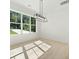 Sunlit room with large windows, hardwood floors, and a modern light fixture at 3920 Bellair Dr, Marietta, GA 30066