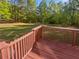 A wooden deck overlooks the expansive yard with a metal cover perfect for summer days at 823 New Hope Rd, Mcdonough, GA 30252