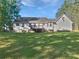 Expansive backyard featuring a charming deck and a well-maintained lawn under a sunny sky at 823 New Hope Rd, Mcdonough, GA 30252