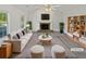 Bright living room featuring a fireplace, vaulted ceilings, and large windows at 823 New Hope Rd, Mcdonough, GA 30252