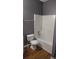 Bathroom featuring toilet next to a shower with white shower surround at 9399 Whaleys Lake Ln, Jonesboro, GA 30238