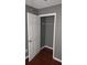 Bedroom with neutral walls, closet storage, and wood-look flooring at 9399 Whaleys Lake Ln, Jonesboro, GA 30238