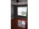 Bedroom features hardwood flooring, neutral paint, and window with blinds at 9399 Whaleys Lake Ln, Jonesboro, GA 30238