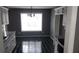 This kitchen space has black tile flooring with white cabinets and stainless steel appliances at 9399 Whaleys Lake Ln, Jonesboro, GA 30238