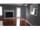 Cozy living room features a fireplace, hardwood floors, and natural light from the door and window at 9399 Whaleys Lake Ln, Jonesboro, GA 30238