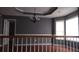 Open-concept living room area with crown molding and natural light with hardwood floors and gray walls at 9399 Whaleys Lake Ln, Jonesboro, GA 30238