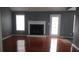 Living room features a fireplace, hardwood floors, and natural light from the window and door at 9399 Whaleys Lake Ln, Jonesboro, GA 30238