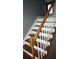 Classic staircase with stained wood treads and white risers and banisters at 9399 Whaleys Lake Ln, Jonesboro, GA 30238