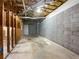Unfinished basement with concrete flooring, block walls, and wooden frames, awaiting your personal design at 131 Diamond Ct, Carrollton, GA 30116
