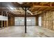 Unfinished Garage is ready for customization; featuring a two-car garage door, ample ceiling height, and natural light at 131 Diamond Ct, Carrollton, GA 30116