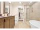 Elegant bathroom featuring a glass shower, freestanding tub, and a wooden vanity at 211 Colonial Homes Nw Dr # 2106, Atlanta, GA 30309