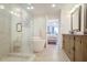 Bright bathroom featuring a glass shower, freestanding tub, and a bedroom view at 211 Colonial Homes Nw Dr # 2106, Atlanta, GA 30309