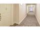 Well-lit hallway with neutral paint and patterned carpet, leading to condo unit at 211 Colonial Homes Nw Dr # 2106, Atlanta, GA 30309