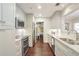 Modern kitchen features white cabinets, granite countertops, and stainless steel appliances at 211 Colonial Homes Nw Dr # 2106, Atlanta, GA 30309