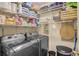 Functional laundry room with shelving, storage baskets, front-load washer and dryer at 211 Colonial Homes Nw Dr # 2106, Atlanta, GA 30309
