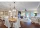Open-concept living and dining room with hardwood floors, fireplace, and modern lighting at 211 Colonial Homes Nw Dr # 2106, Atlanta, GA 30309