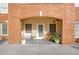 Brick building featuring private patio with outdoor seating and plants at 211 Colonial Homes Nw Dr # 2106, Atlanta, GA 30309