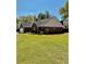 View of the brick house from the backyard, showcasing the lush lawn at 2608 Cascade Cove Dr, Buford, GA 30519
