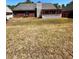 Expansive backyard, features a covered patio, and brick accents on the home's exterior at 2608 Cascade Cove Dr, Buford, GA 30519