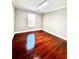 A bedroom featuring hardwood floors, neutral paint, and a bright window at 2608 Cascade Cove Dr, Buford, GA 30519