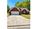 Charming brick home with a well-maintained lawn and a spacious driveway at 2608 Cascade Cove Dr, Buford, GA 30519