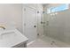 Modern bathroom showcasing a glass enclosed shower and white cabinets, complemented by sleek fixtures at 3735 Tamiami Trl, Cumming, GA 30041