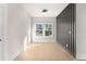 Bright room with a large window and modern accent wall at 3735 Tamiami Trl, Cumming, GA 30041