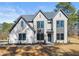 Beautiful two story white brick home with large windows and manicured landscaping at 3735 Tamiami Trl, Cumming, GA 30041
