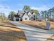 Large two story home with white siding, a three car garage and long driveway at 3735 Tamiami Trl, Cumming, GA 30041