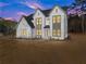 Exterior front view of a large two story home at dusk with manicured landscaping at 3735 Tamiami Trl, Cumming, GA 30041