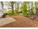 Landscaped backyard featuring a swing set and mulch groundcover, creating a relaxing outdoor space at 4034 Brockett Walk, Tucker, GA 30084