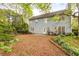 Exterior view of a home with a backyard that has a swing set and green landscaping at 4034 Brockett Walk, Tucker, GA 30084
