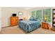 Tranquil bedroom featuring a bed, dresser, and large windows offering natural light at 4034 Brockett Walk, Tucker, GA 30084