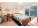 Comfortable bedroom with a bed, side table, and a window overlooking the backyard at 4034 Brockett Walk, Tucker, GA 30084