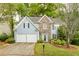 Charming two-story home with stone accents, lush landscaping, and a well-manicured lawn at 4034 Brockett Walk, Tucker, GA 30084