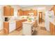 Traditional kitchen featuring wood cabinets, an island, and a view into an adjacent dining area at 4034 Brockett Walk, Tucker, GA 30084