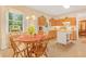 Spacious eat-in kitchen with natural light from large windows, wood cabinets, and center island at 4034 Brockett Walk, Tucker, GA 30084