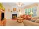 Warm living room featuring a cozy fireplace, soft lighting, and comfortable seating arrangements at 4034 Brockett Walk, Tucker, GA 30084