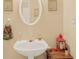 Half bathroom with a pedestal sink, decorative mirror, and neutral wall color at 4034 Brockett Walk, Tucker, GA 30084