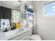 Clean bathroom featuring a patterned shower curtain, modern storage, and plenty of natural light at 611 King Arnold St, Atlanta, GA 30354