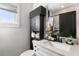 Stylish half-bathroom featuring a modern sink, vanity, and sleek, space-saving black storage cabinet at 611 King Arnold St, Atlanta, GA 30354