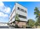 Modern townhome featuring a brick facade and architectural paneling, complemented by professional landscaping and mature trees at 611 King Arnold St, Atlanta, GA 30354
