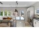 Kitchen features stainless steel appliances, pendant lighting, light countertop and an island with black countertop at 611 King Arnold St, Atlanta, GA 30354